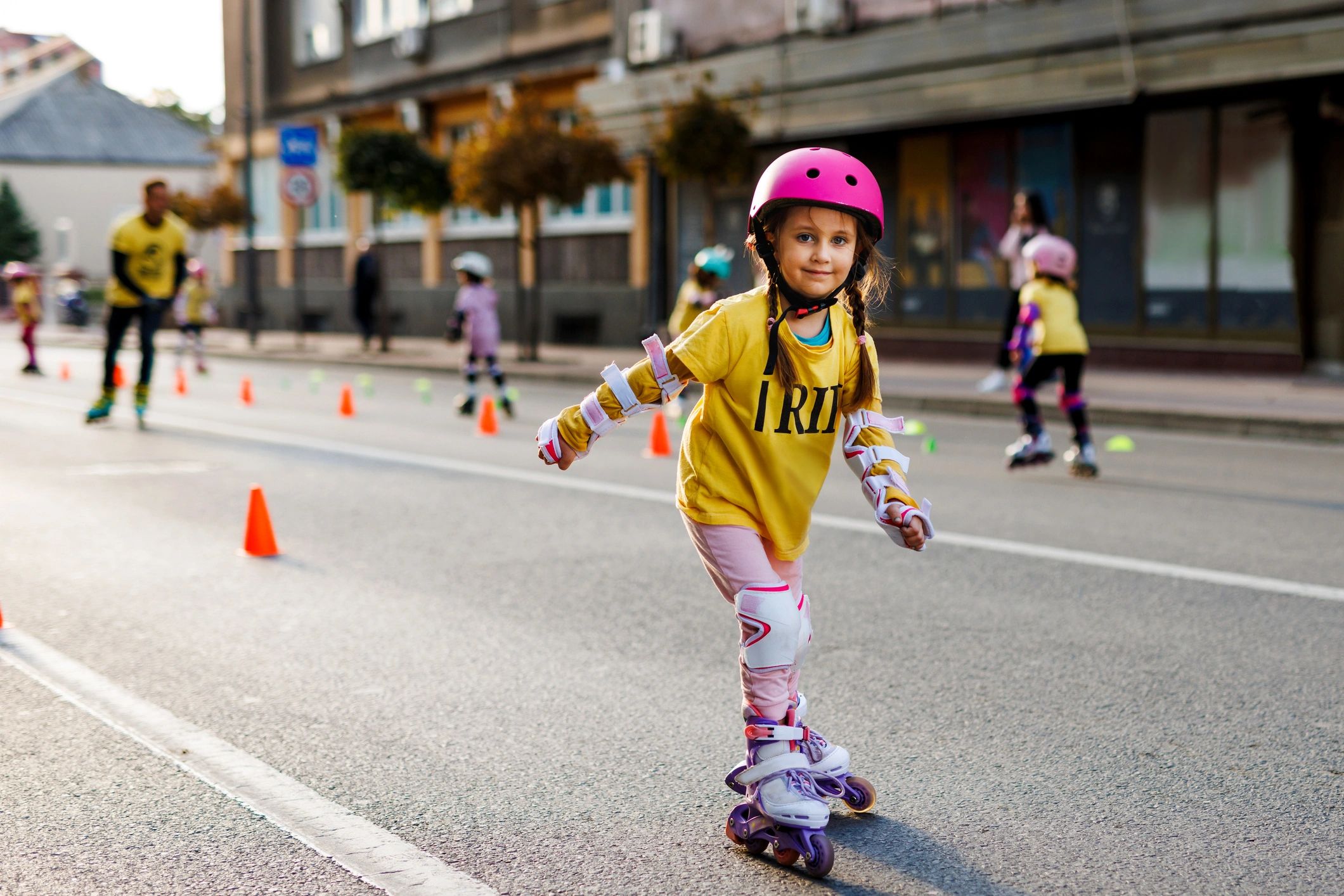 Smiling child roller skating outdoors