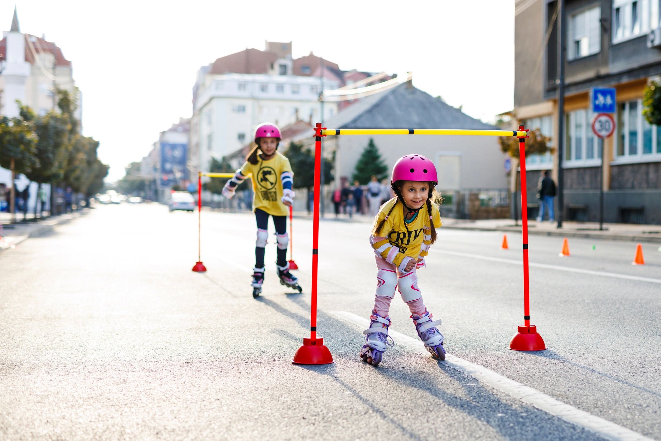 Child learning roller skating in the city