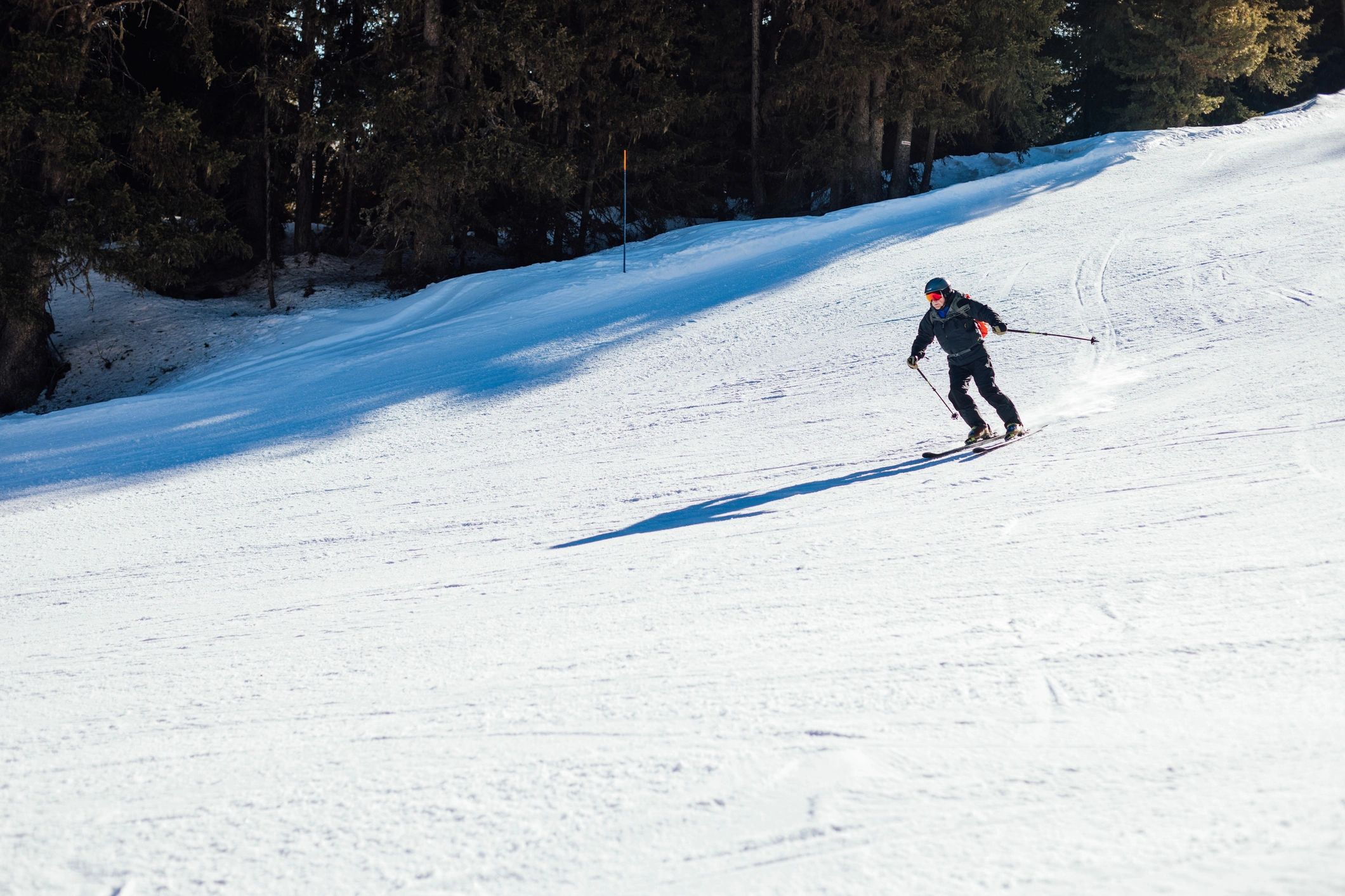 Skier carving a turn on a snowy slope