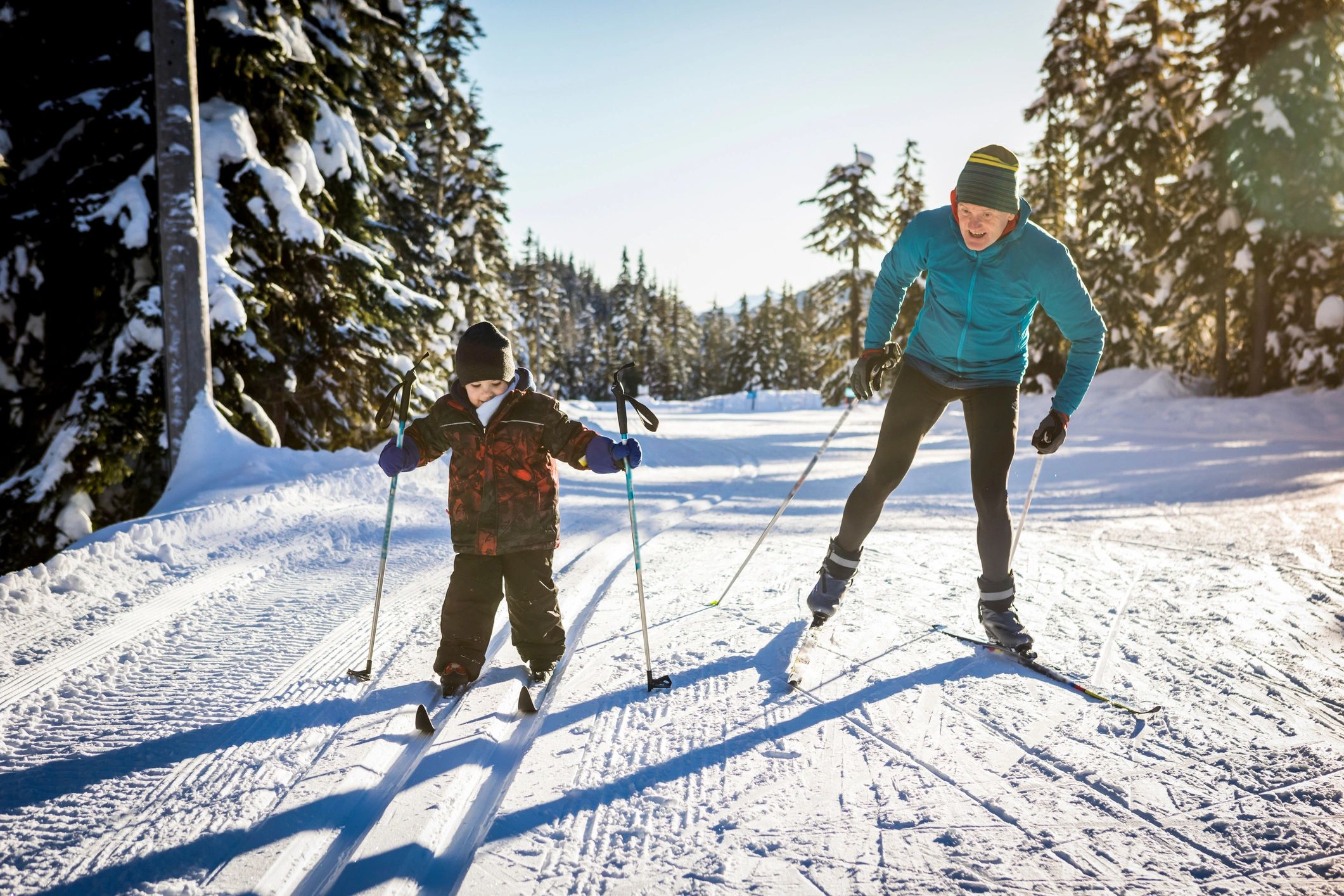 Coach skiing with a child