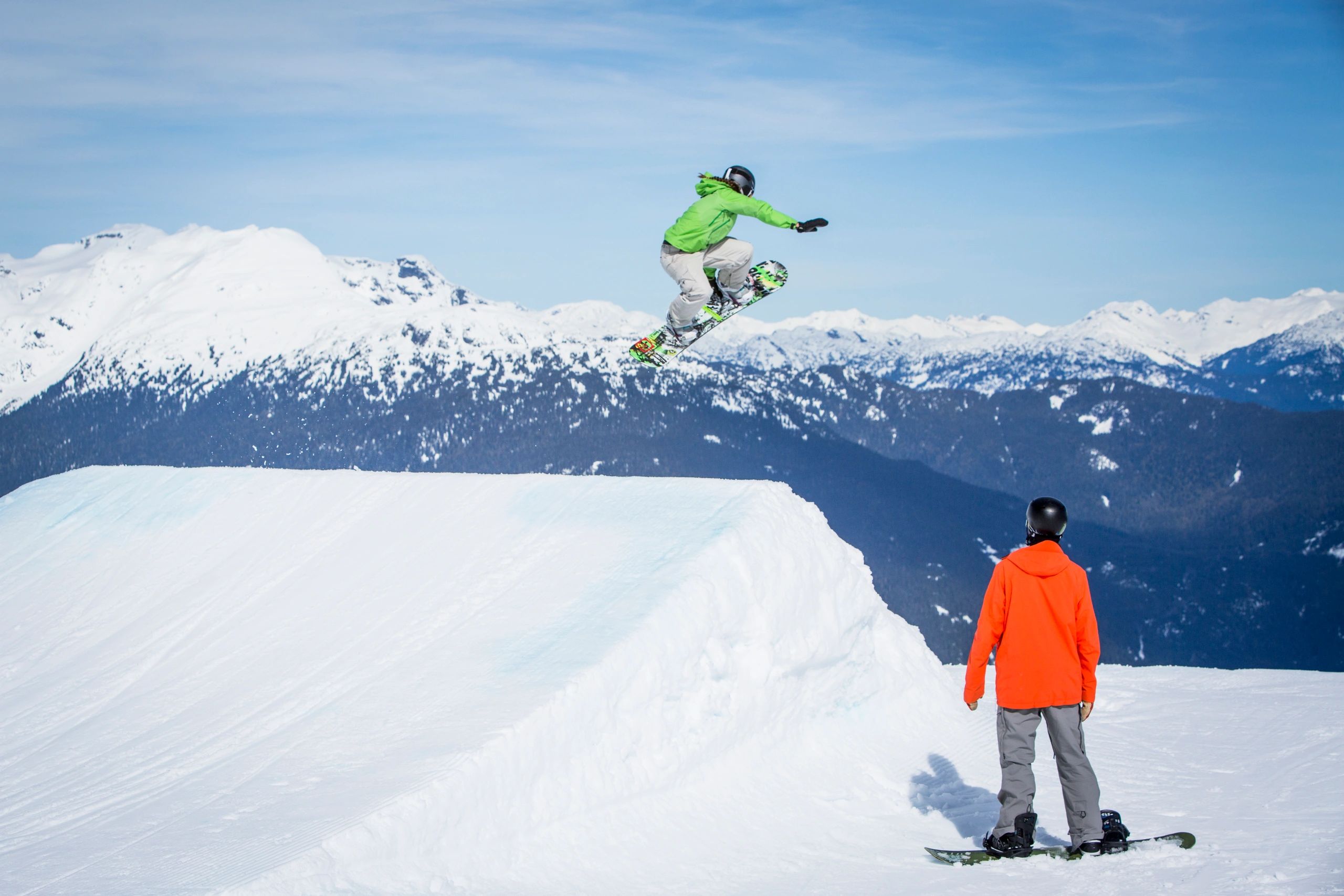 Snowboarding instructor coaching a student at a ski resort