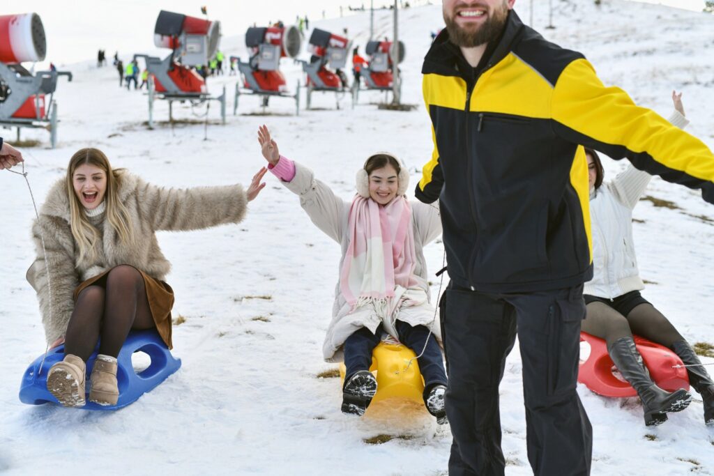 Winter Fun: Group of Friends Sledding Outdoors